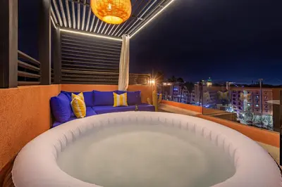 a large bath tub in a room with a window at Private Luxury Penthouse Marrakech with Jacuzzi & Pool in Marrakech
