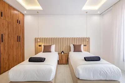 two beds sitting next to each other in a bedroom at Private Luxury Penthouse Marrakech with Jacuzzi & Pool in Marrakech