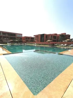 a large swimming pool in a building at Cosy appartement , Marrakech Noria golf in Marrakech