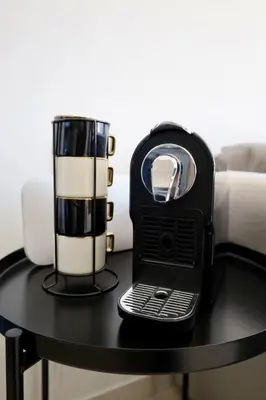 a black and white blender sitting on a table at Cosy appartement , Marrakech Noria golf in Marrakech