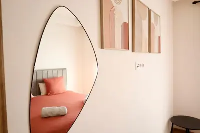 a mirror in a room with a bed at Cosy appartement , Marrakech Noria golf in Marrakech