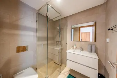 a bathroom with a shower and a toilet and a sink at Noria Golf Marrakech pool view 2 bedrooms garden in Marrakech