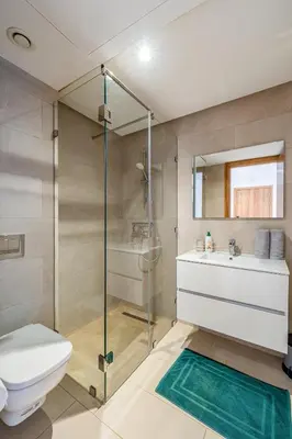 a bathroom with a shower and a toilet and a sink at Noria Golf Marrakech pool view 2 bedrooms garden in Marrakech