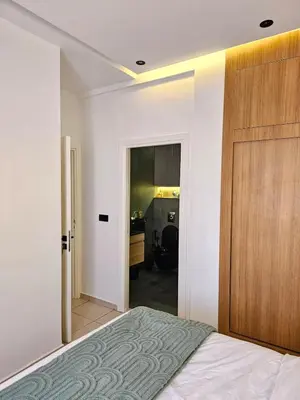a bedroom with a bed and a wooden door at Amber Haven in Marrakech