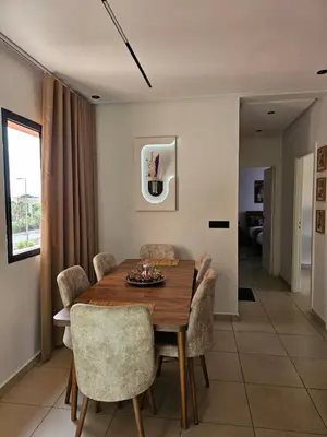 a dining room with a wooden table and chairs at Amber Haven in Marrakech