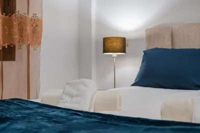 a bedroom with a bed and a blue pillow at Almaya Stay City Center in Marrakech