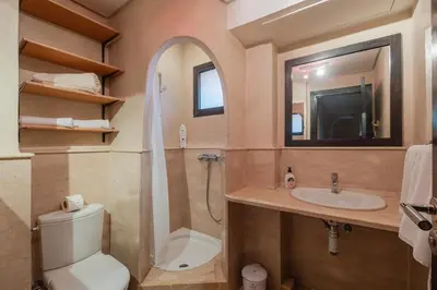 a bathroom with a toilet and a sink and a mirror at Almaya Stay City Center in Marrakech
