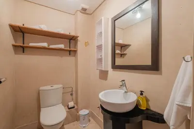 a bathroom with a sink and a toilet and a mirror at Almaya Stay City Center in Marrakech