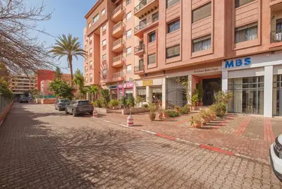 an empty street in front of a large building at Almaya Stay City Center in Marrakech