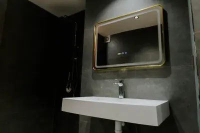 a bathroom with a sink and a tv on the wall at Appartement moderne in Marrakech