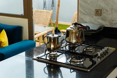 a stove with two tea pots on top of it at Appartement moderne in Marrakech
