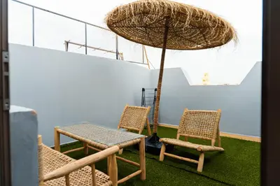 a table and two chairs and an umbrella at Appartement moderne in Marrakech