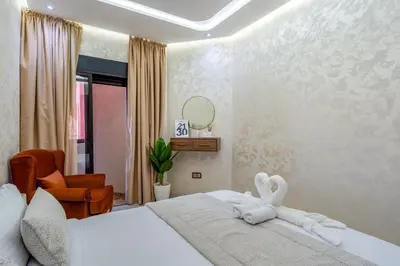 a bedroom with a bed with a towel animal on it at New 2BR Apartment in Marrakech with Pools, Gym, Security & Terrace in Marrakech