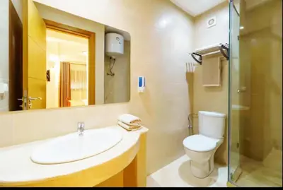 a bathroom with a sink and a toilet and a mirror at Luxury apartment in Hivernage in Marrakech
