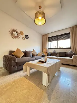 a living room with a couch and a table at Cozy opera - Hivernage - Gare in Marrakech