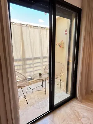 a mirror in a room with a table and chairs at Cozy opera - Hivernage - Gare in Marrakech