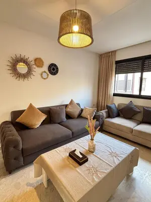 a living room with a couch and a table at Cozy opera - Hivernage - Gare in Marrakech