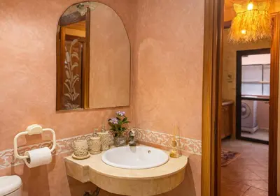 a bathroom with a sink and a mirror at Andalous Prestige in Marrakech