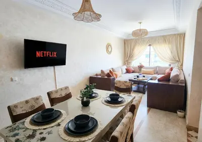 a living room with a table and a couch at Andalous Prestige in Marrakech