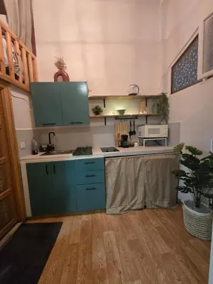 a kitchen with blue cabinets and a sink at Studio cosy Résidence Qariya Siyahiya in Marrakech
