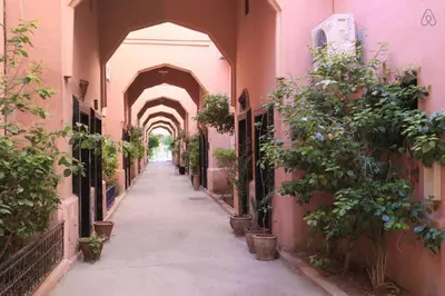 an alley with an archway with potted plants at Studio cosy Résidence Qariya Siyahiya in Marrakech