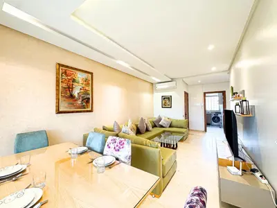 a living room with a couch and a table at Prestigia Golf View - Piscine & terrasse in Marrakech