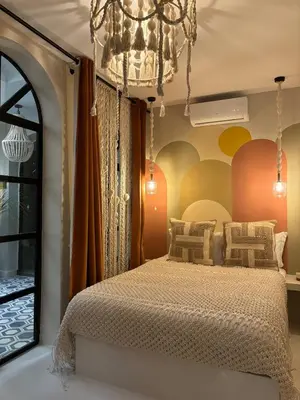a bedroom with a bed and a chandelier at Private Riad in Marrakech Medina in Marrakech