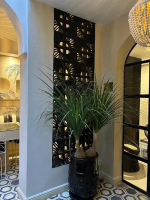 a black vase with a plant in a room at Private Riad in Marrakech Medina in Marrakech