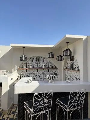 a kitchen with black and white dishes on the wall at Private Riad in Marrakech Medina in Marrakech
