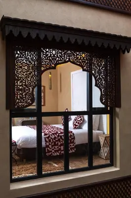 a room with a bed through a window at Riad Dar Shala in Marrakech