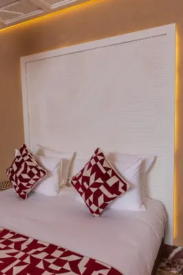 a bed with red and white pillows on it at Riad Dar Shala in Marrakech