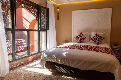 a bedroom with a large bed and a window at Riad Dar Shala in Marrakech