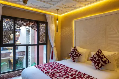 a bedroom with a large bed and a window at Riad Dar Shala in Marrakech