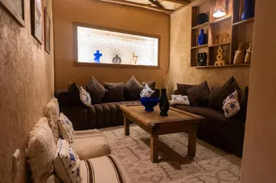 a living room with a couch and a table at Riad Amara Private pool breakfast in Marrakech