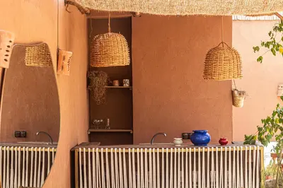 a room with a table and two chandeliers at Riad Amara Private pool breakfast in Marrakech