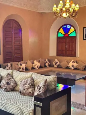 a living room with a couch and a stained glass window at Villa Oum Palace in Marrakech