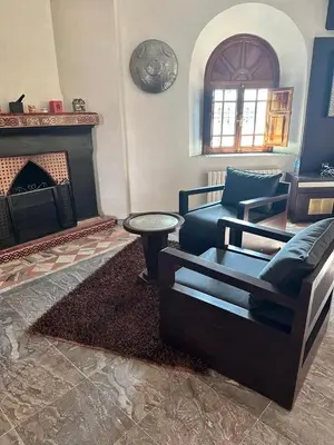 a living room with a couch and a fireplace at Villa Oum Palace in Marrakech