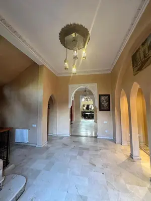 an empty room with a chandelier on the ceiling at Villa Oum Palace in Marrakech