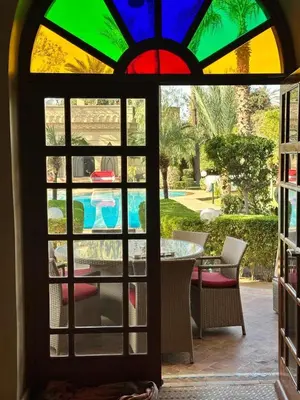 a view through a window of a patio with a table at Villa Oum Palace in Marrakech