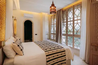 a bedroom with a large bed and a large window at Riad Ever - Entièrement privatisé in Marrakech