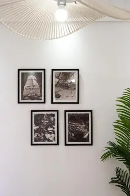 a group of framed pictures on a wall at Appartement de luxe au Plaza, au coeur de Marrakech in Marrakech