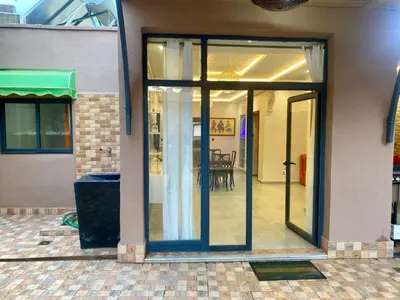 a sliding glass door leading to a dining room at Villa d'Exception avec Piscine Privée in Marrakech