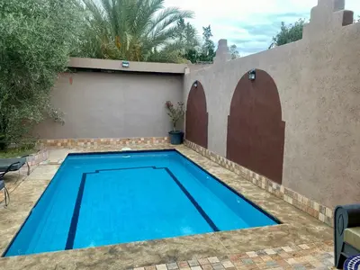 a swimming pool in the backyard of a house at Villa d'Exception avec Piscine Privée in Marrakech