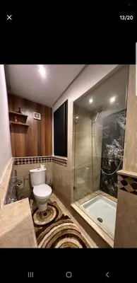 a bathroom with a shower and a toilet and a tub at Le petit cocon in Marrakech