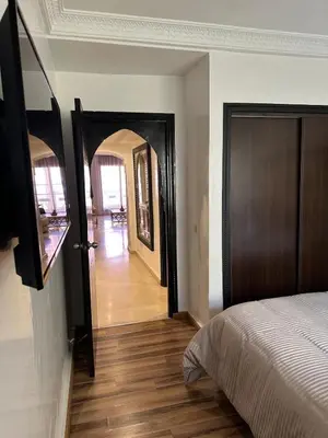 a bedroom with a door leading to a hallway at Le petit cocon in Marrakech