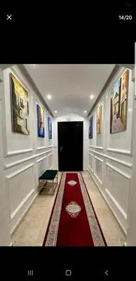 a hallway with a red carpet and a black door at Le petit cocon in Marrakech
