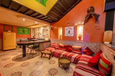 a living room with a couch and a table at Riad Marrakech 88 Retro Chic 3 Rooms with Shared Pool in Marrakech
