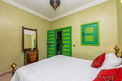 a bedroom with green and white doors and a bed at Riad Marrakech 88 Retro Chic 3 Rooms with Shared Pool in Marrakech