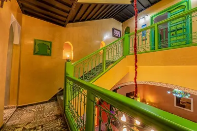 a spiral staircase with green railings in a building at Riad Marrakech 88 Retro Chic 3 Rooms with Shared Pool in Marrakech