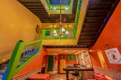 a living room with a staircase and a chandelier at Riad Marrakech 88 Retro Chic 3 Rooms with Shared Pool in Marrakech